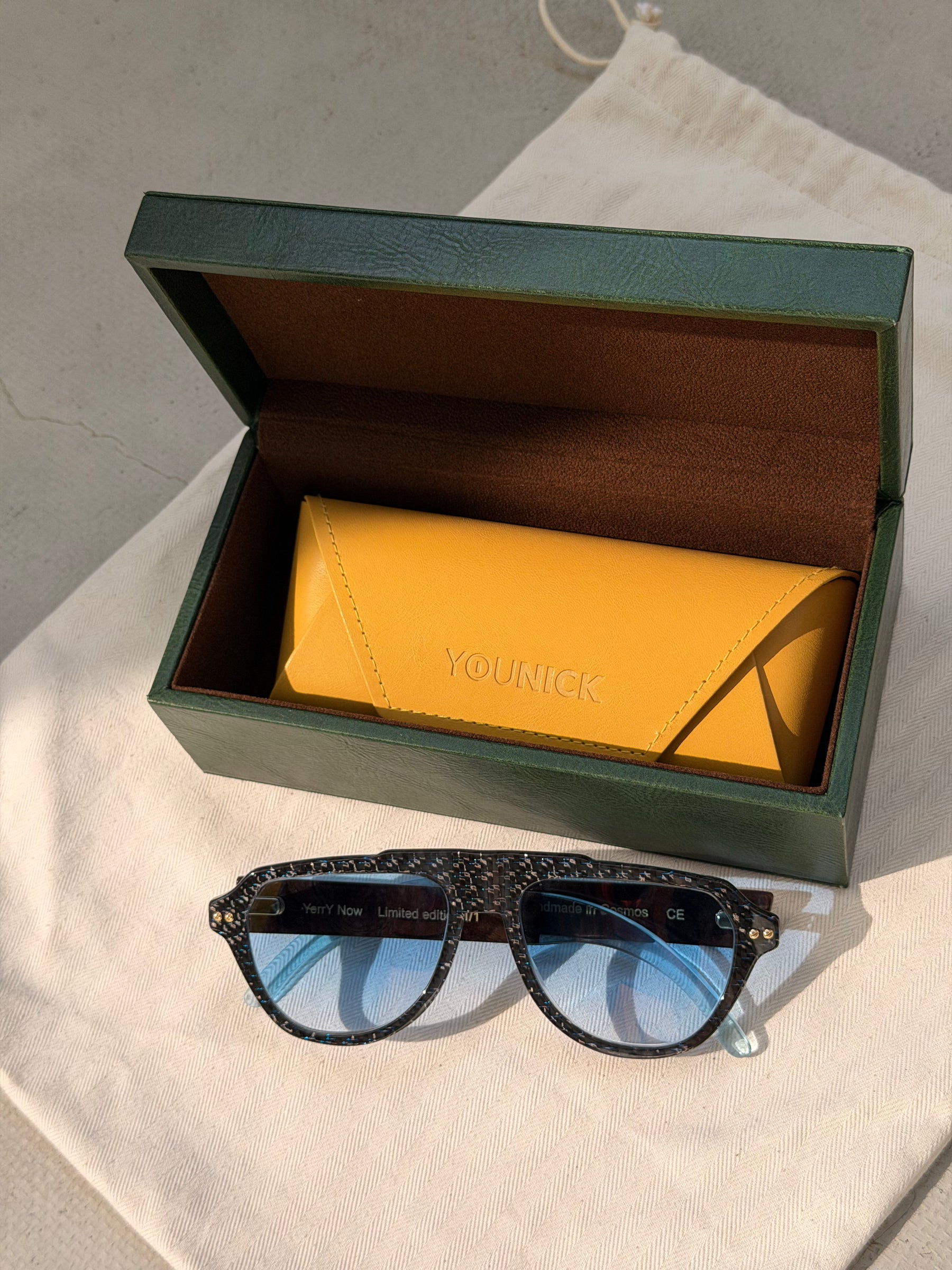 YerryNow One in front of an open green YouNick box with a yellow case