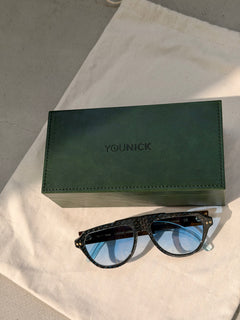 Green YouNick box and YerryNow One eyewear on a linen pouch
